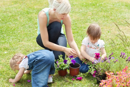 Gardener demonstrating safe, accessible pathways and tactile markers in a suburban Muswell Hill garden